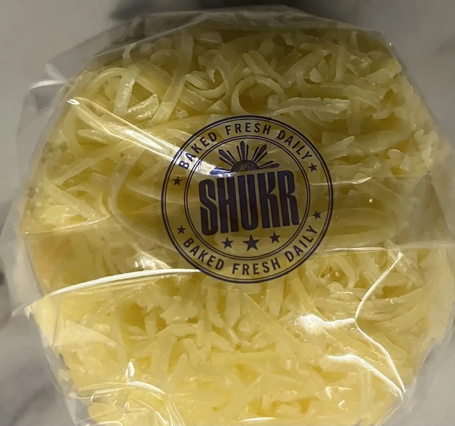 A wrapped SHUKR ensaymada with the Baked Fresh Daily stamp